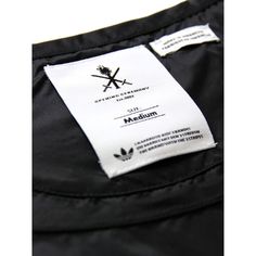 a label on the back of a black jacket