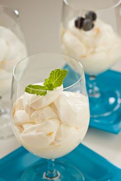 two glasses filled with ice cream on top of a blue tray