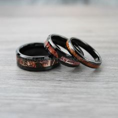 two wedding rings with camouflage print on them sitting on a table next to each other