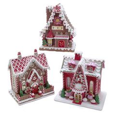 three gingerbread houses are decorated with candy canes