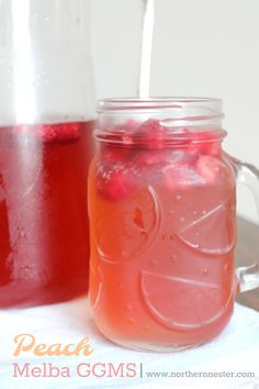 two mason jars filled with liquid sitting on top of a table