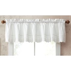 a white window valance hanging on the side of a wall