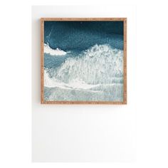 a painting hanging on the wall next to a wooden frame with an ocean scene painted on it