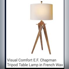 a tripod table lamp in french wax with a white shade on the top and bottom