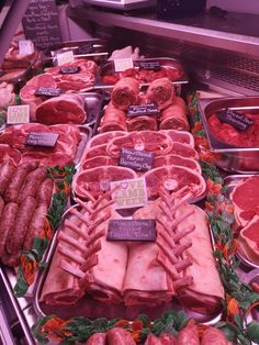 meats and sausages on display at a market