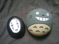 two rocks with cartoon faces painted on them