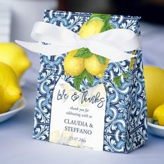 a blue and white box with lemons on it sitting next to two bowls of lemons