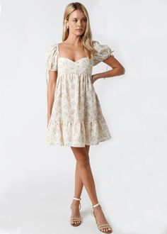 Throw on the Jessie Cream and Pink Floral Babydoll Mini Dress and meet your friends for brunch! Woven cream and pink floral fabric shape a sweetheart neckline, empire bodice, and puffy short sleeves with ties and elasticized shoulders. The babydoll silhouette continues to a flirty mini skirt with a ruffle hem. DETAILS & FIT S: 29" Length, 24" Bust, 44" Hips M: 30" Length, 26" Bust, 46" Hips L: 30.5" Length, 29" Bust, 48" Hips Short Babydoll Bodice. 100% Cotton. Machine wash cold. Imported. Cream Babydoll Dress, Winfo Dresses Short, Pink Babydoll Dress, Cute Mini Dresses, Pink Floral Fabric, Stylish Fits, Church Fits, Babydoll Mini Dress, Banquet Dresses