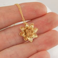 "This lotus flower pendant makes for such a sweet and feminine necklace. The details on the lotus are so delicate and timeless, and it's just such a cute size. I love the little capillaries visible in the petals and the little sprigs in the center of the flower. The details really are just perfect and so very dainty. I've kept everything as minimal as possible, and made the option of adding some stellar amethyst cushion cut dangles if you want some sparkle to go with the slightly matte flower. R Luxury Traditional Flower Pendant Jewelry, Affordable Bohemian Flower Pendant Necklace, Cheap Gold Charm Necklace With Flower Pendant, Luxury Flower Pendant Necklace As Gift, Luxury Flower-shaped Necklace For Gift, Cheap Elegant Flower Pendant Jewelry, Cheap Elegant Flower Pendant Necklace, Affordable Gold Adjustable Flower Necklace, Luxury Gold Plated Flower Pendant Jewelry