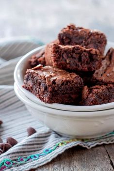 a bowl filled with brownies sitting on top of a table