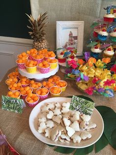 a table topped with lots of food and cupcakes