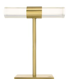 a gold table lamp with a glass shade on it's base and a white light in the middle