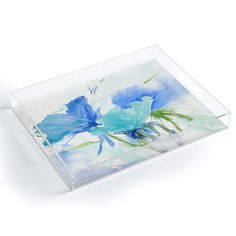 a glass tray with blue flowers painted on it