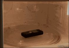 a remote control sitting on top of a white plate in a microwave oven with water running down the side