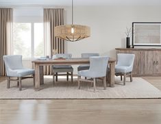 a dining room table with blue chairs and a chandelier hanging from the ceiling