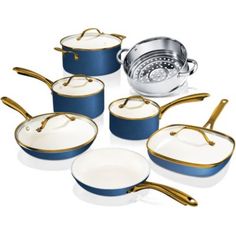 an assortment of pots and pans with gold trimming on the lids, in blue and white