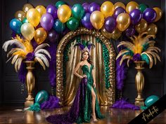 a woman standing in front of a backdrop with balloons and streamers on the floor