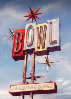 a sign that says bowl on top of it with birds flying around the letters below