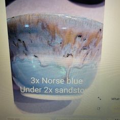 a blue bowl sitting on top of a computer screen