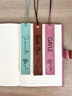 three bookmarks with the words date and live in love written on them hanging from cords