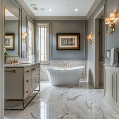 a large bathroom with marble floors and white tub in the center, framed pictures on the wall