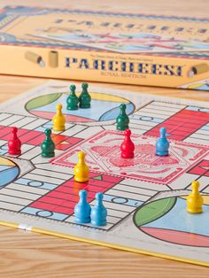 a board game with pieces on the board and in front of it is a yellow box