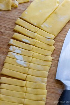 the cheese is cut up and ready to be put into the pizza crusts on the cutting board