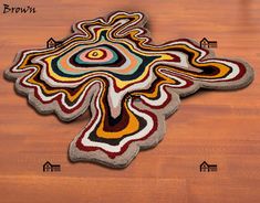 a cross shaped rug on top of a wooden floor with arrows pointing in different directions