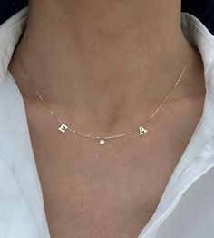 This 14K gold necklace features 2 letters + 1 dangling diamond in between. Choose 2 letters to create your custom necklace! EXAMPLE: Left Letter: N Right Letter: T Available in 14K Yellow Gold or 14K White Gold Letter Measurement: Approx. 0.20" (varies slightly per letter) Uppercase letters only Letters and diamond spaced approx. 1" apart FINAL SALE Necklace With Diamond, Name Letters, Letter N, Gold Letter, 14k Gold Necklace, Squad Goals, Uppercase Letters, Letter T, Gold Letters