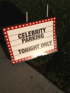 a sign that says celebrity parking tonight only on the side of the road in front of some grass