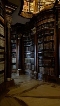 an old library with many bookshelves and chandelier hanging from the ceiling