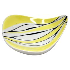 a yellow and white bowl with black lines on it