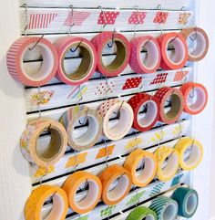 a rack with washi tapes hanging from it's sides and the words, 30 another way to arrange your washi tape using a shutter