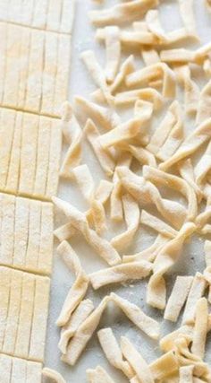 uncooked pasta on a cutting board ready to be cut into smaller pieces and put in the oven