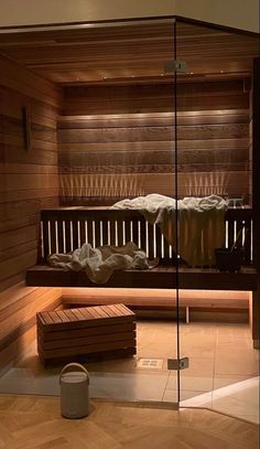 a sauna in a wooden room with glass walls