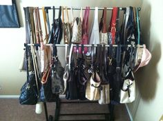 a rack with many purses hanging on it