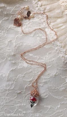 a close up of a necklace on a lace surface