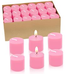 pink candles in a cardboard box on a white background