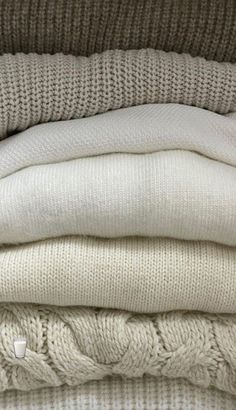 several sweaters stacked on top of each other