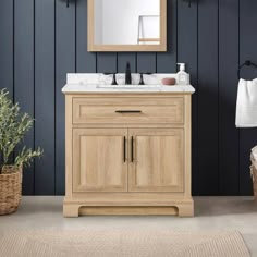 a white sink sitting under a mirror next to a wooden cabinet