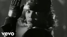 a black and white photo of a woman wearing a helmet with her hands in the air