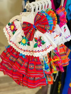 colorful clothing is hanging on a rack in a store