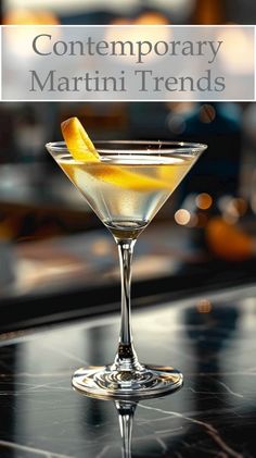 a martini glass with a lemon wedge in it and the words contemporary martini trends