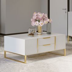 a white and gold coffee table with flowers on top