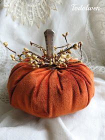 an orange pumpkin with some flowers on it