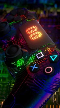 a close up of a controller with neon lights on the top and bottom part of it