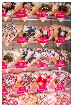 a display case filled with lots of different types of desserts and toppings on top of each other