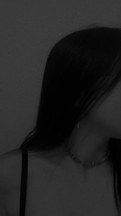 black and white photograph of a woman with her back to the camera, wearing a choker