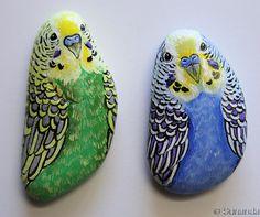 two painted rock birds sitting on top of each other