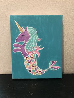 an acrylic painting of a mermaid unicorn on a blue background with pink and green colors